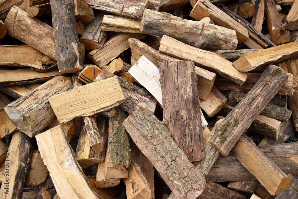 Lots of chopped oak firewood. Natural background. Lots of chopped oak firewood. Natural background.