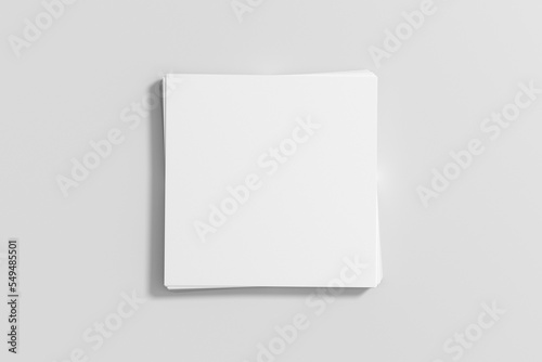 Stack of square paper sheets on the white wooden table