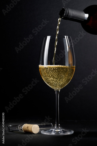 Pouring sparkling white wine into a glass
