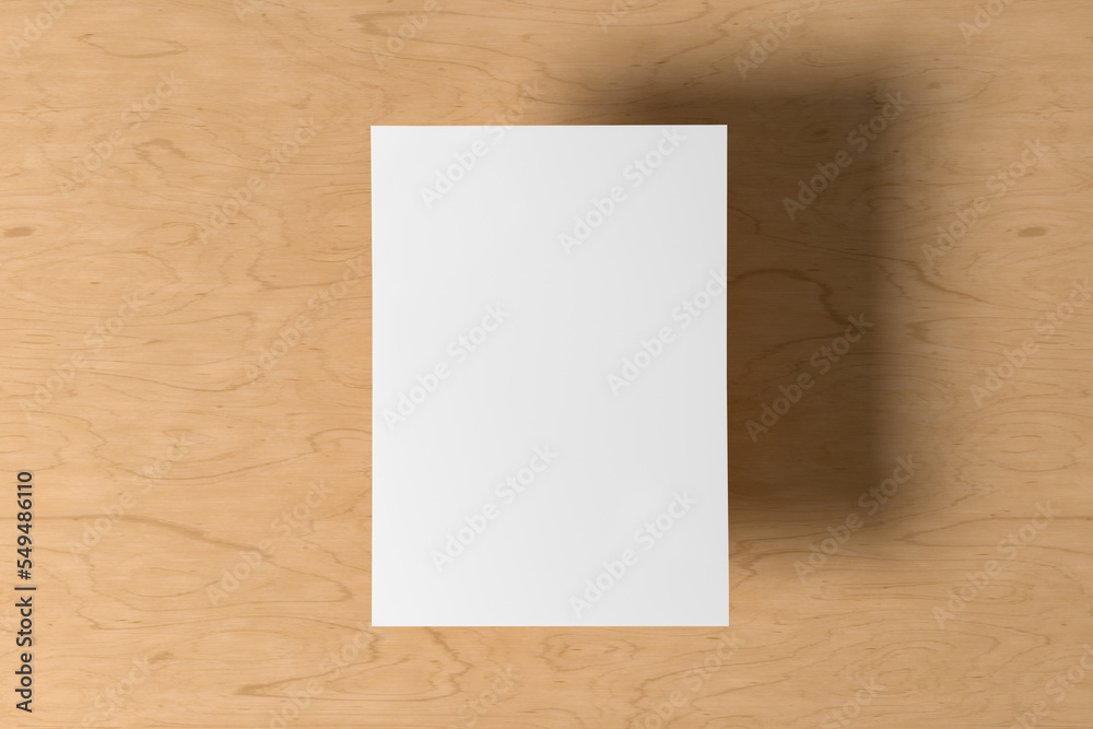 A sheet of paper mock up floating above the wooden table table. A sheet of paper mock up floating above the wooden table table.