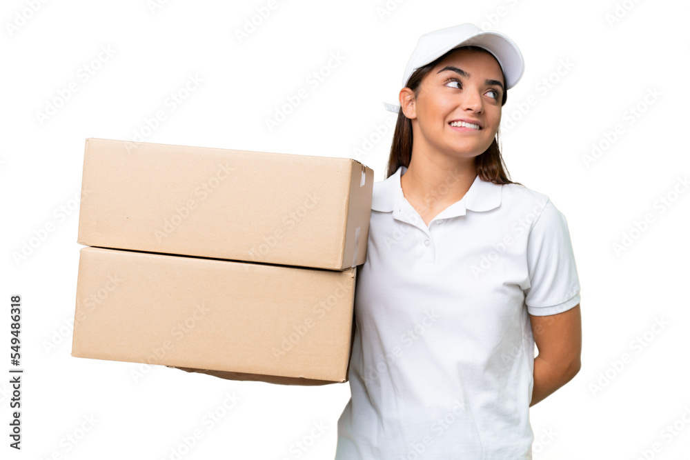 Delivery caucasian woman holding boxes isolated on green chroma background thinking an idea while looking up Delivery caucasian woman holding boxes isolated on green chroma background thinking an idea while looking up
