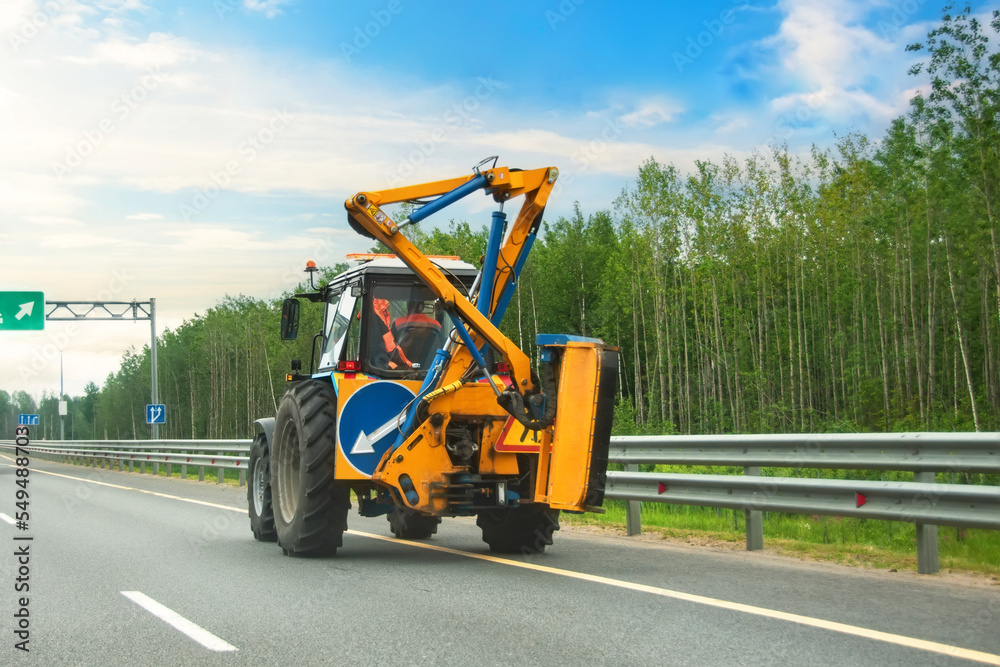 Tractor with road sign arrow detour and brush arrow crane for washing bumper or highway guardrail. Tractor with road sign arrow detour and brush arrow crane for washing bumper or highway guardrail.