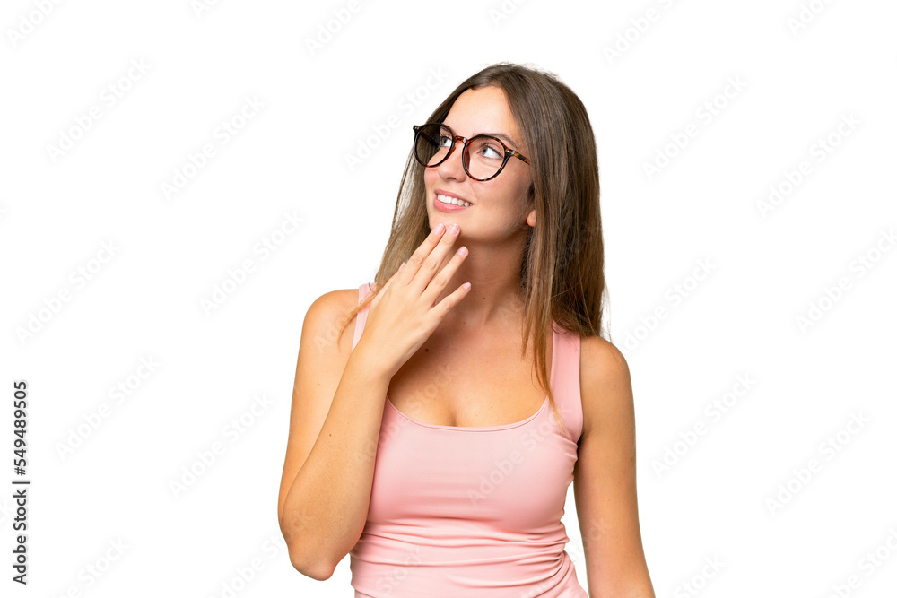 Young pretty woman over isolated background looking up while smiling Young pretty woman over isolated background looking up while smiling