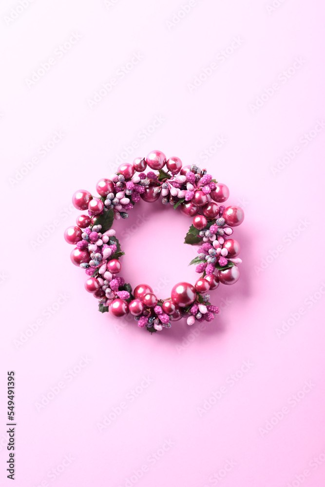 Christmas Wreath on bright paper background. Top view. Copy space. 