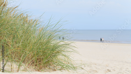 Strand an der Küste von Swinoujscie an der polnischen Ostseeküste. Im Hintergrund unscharfe Spaziergänger.