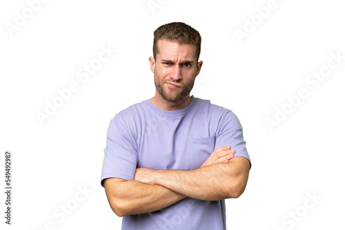 Young handsome caucasian man isolated on green chroma background with unhappy expression