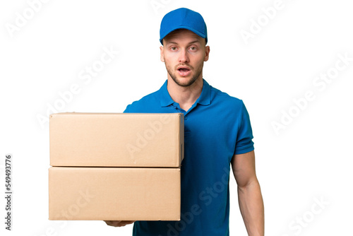 Delivery caucasian man over isolated background with surprise facial expression © luismolinero
