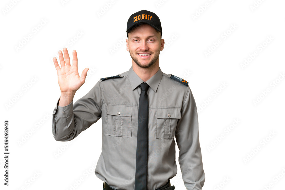 Young security caucasian man over isolated background saluting with hand with happy expression Young security caucasian man over isolated background saluting with hand with happy expression