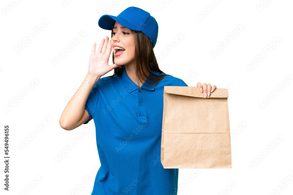 Young beautiful caucasian woman taking a bag of takeaway food over isolated background shouting with mouth wide open to the side