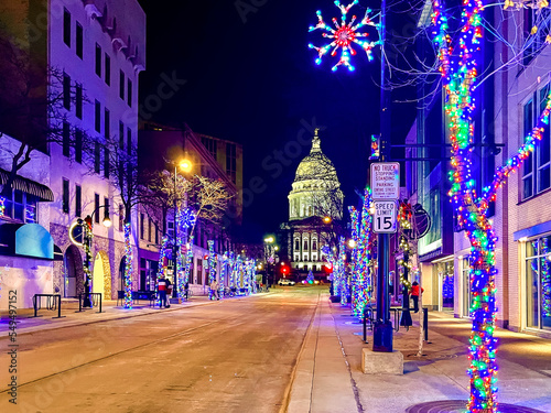 Looking down State Street in downtown Madison, Wisconsin at night with the State Capitol and holiday lights. photo