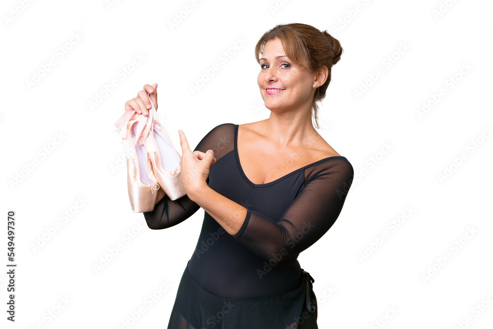 Middle-aged caucasian woman practicing ballet over isolated background pointing back Middle-aged caucasian woman practicing ballet over isolated background pointing back