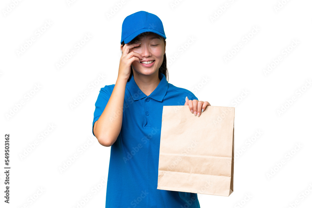 Young Asian woman taking a bag of takeaway food over isolated background laughing Young Asian woman taking a bag of takeaway food over isolated background laughing