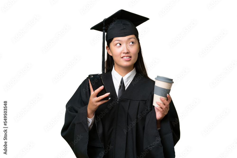 Young university graduate Asian woman over isolated background holding coffee to take away and a mobile while thinking something Young university graduate Asian woman over isolated background holding coffee to take away and a mobile while thinking something