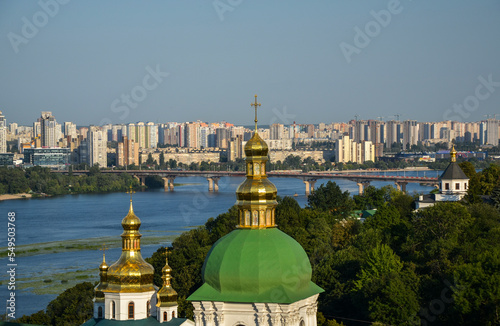 Coupolas of Kyiv Pechersk Lavra Monastery, Paton bridge, and modern residential buildings at the left bank of rhe Dnipro river at the capital of Ukraine  photo