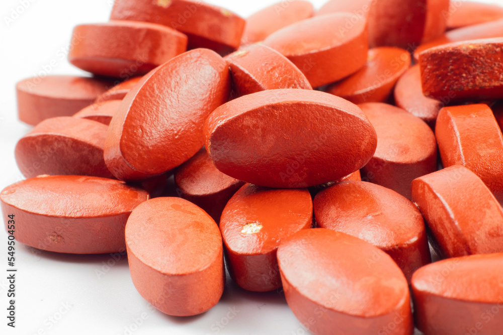 Red vitamin tablets
on a white background. Red pills may represent painkillers. Red vitamin tablets
on a white background. Red pills may represent painkillers.