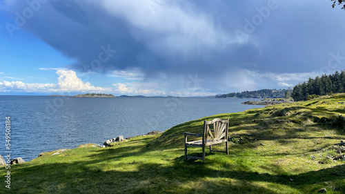 A bench looking at the Pacific Ocean on the East Coast of Vancouver Island in Nanoose Bay, British Columbia, Canada photo