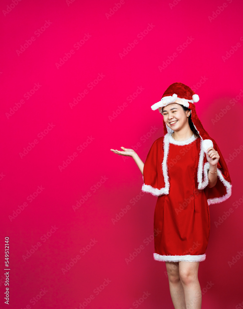 An Asian Woman Posing on a Isolated Red Background With Christmas Attire on a Red Background An Asian Woman Posing on a Isolated Red Background With Christmas Attire on a Red Background