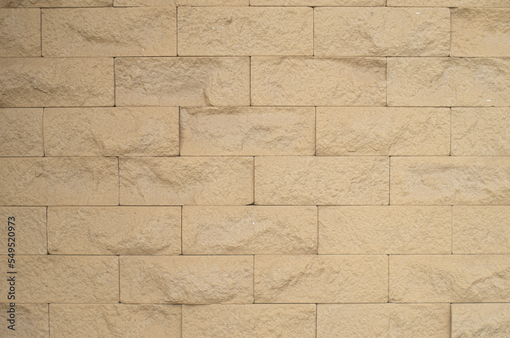 Fototapeta premium New yellow stone wall close up