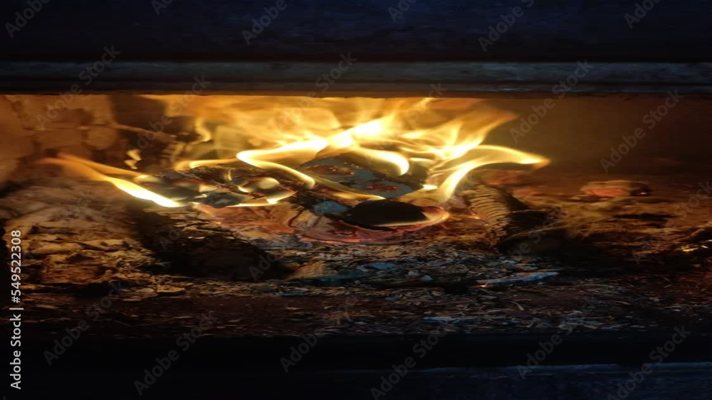 Vertical video. Firewood burns with fire in the oven Vertical video. Firewood burns with fire in the oven