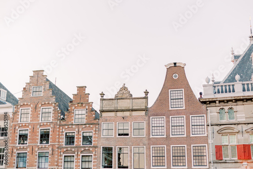 Magnificent old rooftops of different kinds in a small Dutch town. The sky is cloudy and summer is in the air.