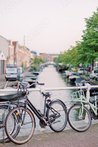 A typical picture from a small Dutch town: Several bicycles are leaning against a bridge over a small river.
