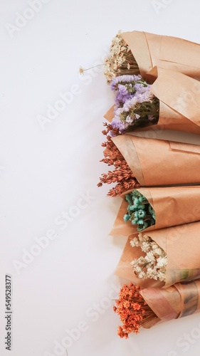 Small bouquets of flowers with lavender, limonium, dried flowers, wrapped in kraft paper, a nice little gift photo