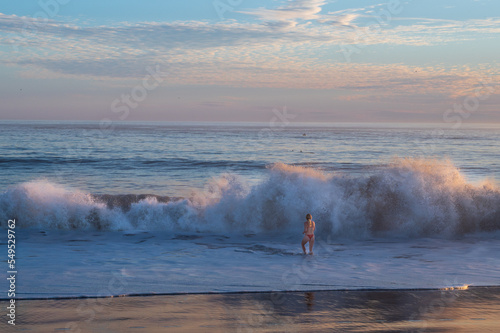 woman in waves on the beach
