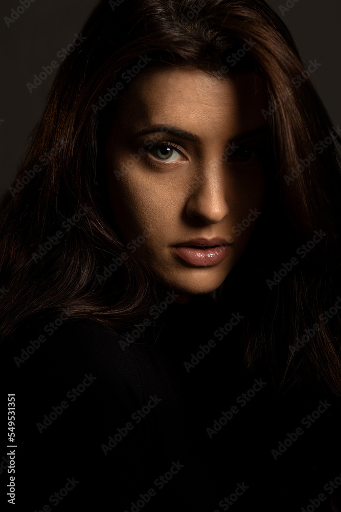Headshot of beautiful young woman in black dress and gray background Headshot of beautiful young woman in black dress and gray background