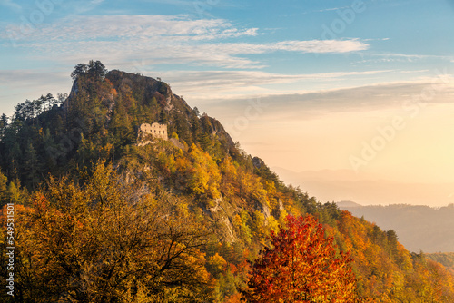 The ruins of the medieval Vrsatec castle at autumn sunset. The Vrsatec National Nature Reserve in the White Carpathian Mountains, Slovakia, Europe. photo