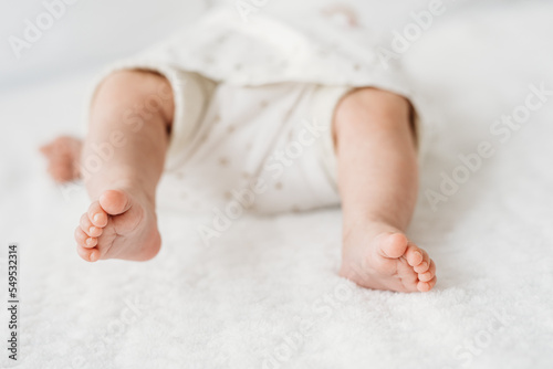 tiny newborn baby feet in bed close up detail 