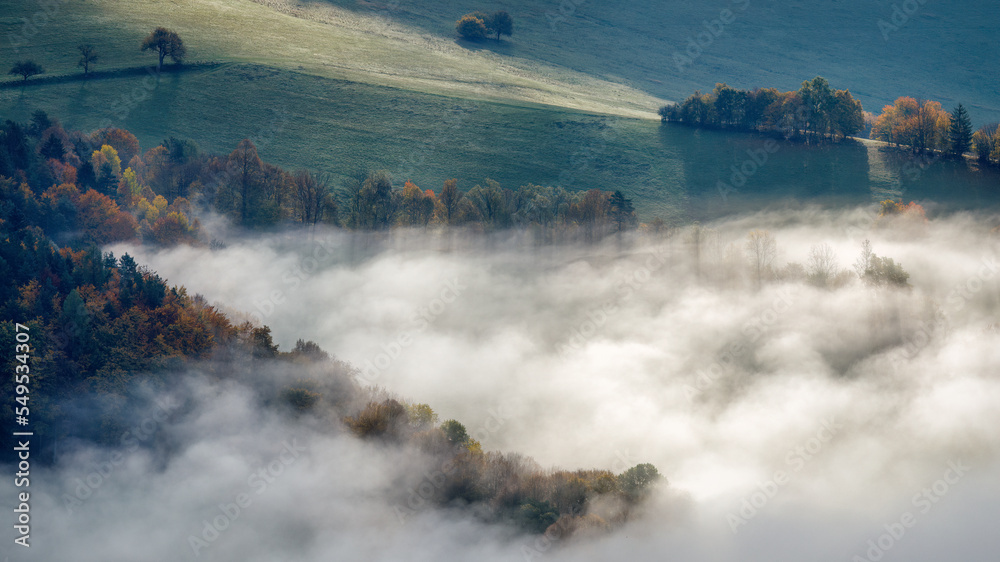 Landscape of foggy valley in an autumn morning. The Sulov Rocks, national nature reserve in northwest of Slovakia, Europe.