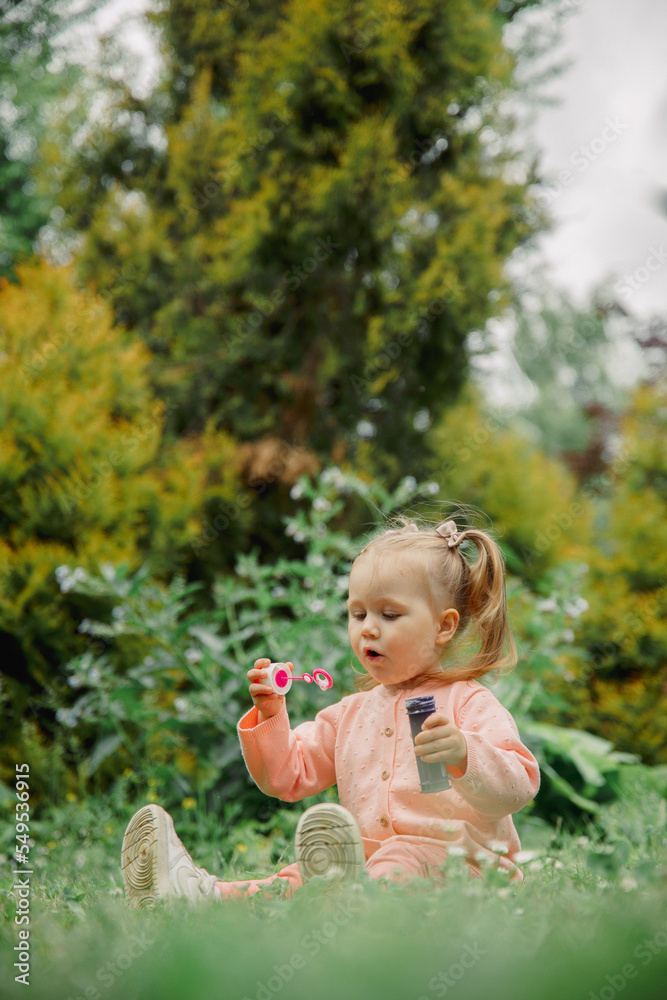 little child playing in the park in soap bubbles little child playing in the park in soap bubbles