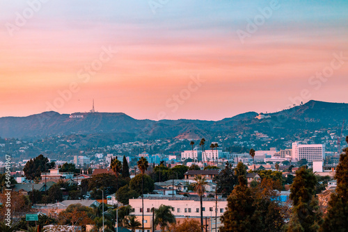 Fotografiet Los Angeles, California landscape with the hollywood sign and griffith observatory in the background during sunset
