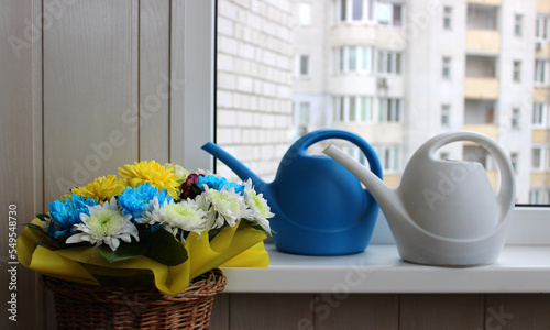 Flowers Bouquet Near White And Blue Long Mouth Watering Cans On A Windowsill Of House Balcony 
