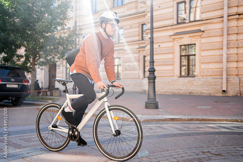 Fototapeta Naklejka Na Ścianę i Meble -  A man on a bicycle goes to work urban eco transport