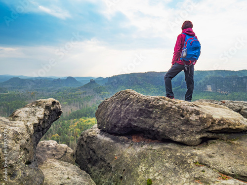 Woman cary blue back pack wear red jacket watch over landscape