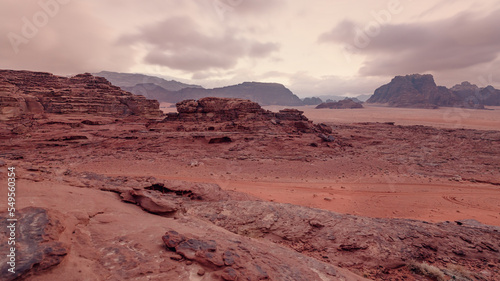 Red orange Mars like landscape in Jordan Wadi Rum desert, mountains background, overcast morning. This location was used as set for many science fiction movies