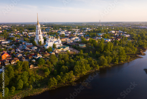 Aerial view of Shuya Orthodox Resurrection cathedral and bell tower on background with Teza River and cityscape, Russia..