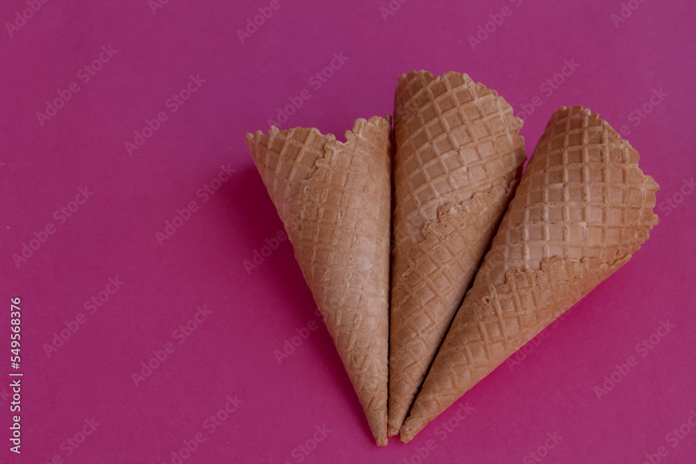 Collection of empty ice cream cones on pink color background Collection of empty ice cream cones on pink color background