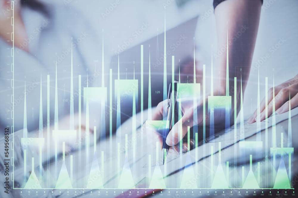 A woman hands writing information about stock market in notepad. Forex chart holograms in front. Concept of research. Double exposure A woman hands writing information about stock market in notepad. Forex chart holograms in front. Concept of research. Double exposure