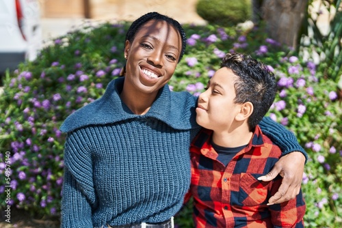 African american mother and son smiling confident hugging each other at park