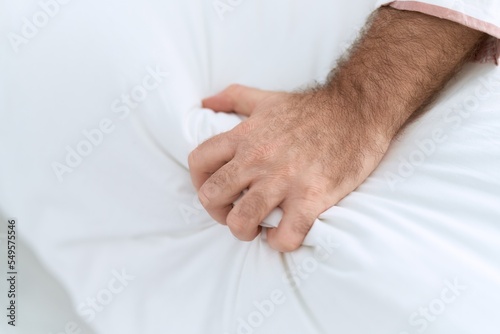 Middle age man having orgasm on bed at bedroom