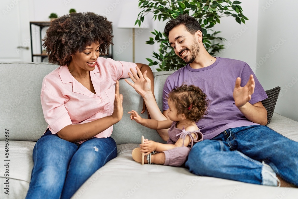 Couple and daughter smiling confident sitting on sofa at home Couple and daughter smiling confident sitting on sofa at home