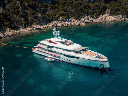 Aerial drone view of luxury private yacht anchored on porto timoni beach in corfu