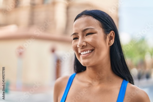 Young beautiful latin woman smiling confident looking to the side at street Free Download Young beautiful latin woman smiling confident looking to the side at street - GFXLoad