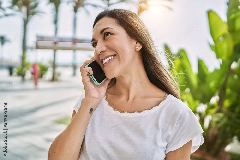 Young hispanic woman smiling confident talking on the smartphone at street Young hispanic woman smiling confident talking on the smartphone at street