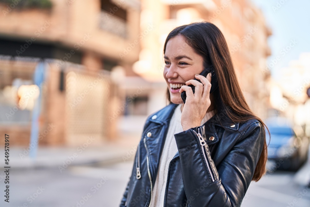 Young woman smiling confident talking on the smartphone at street Young woman smiling confident talking on the smartphone at street