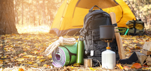 Fotografía Tourist's survival kit and camping tent in autumn forest