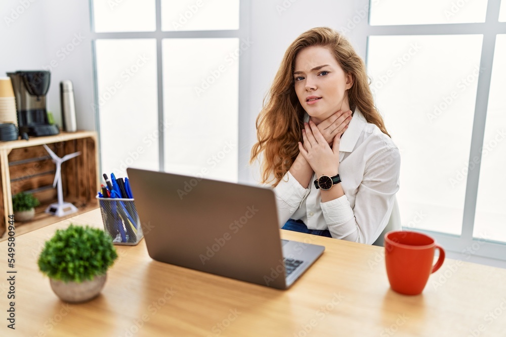 Young caucasian woman working at the office using computer laptop shouting suffocate because painful strangle. health problem. asphyxiate and suicide concept. Young caucasian woman working at the office using computer laptop shouting suffocate because painful strangle. health problem. asphyxiate and suicide concept.