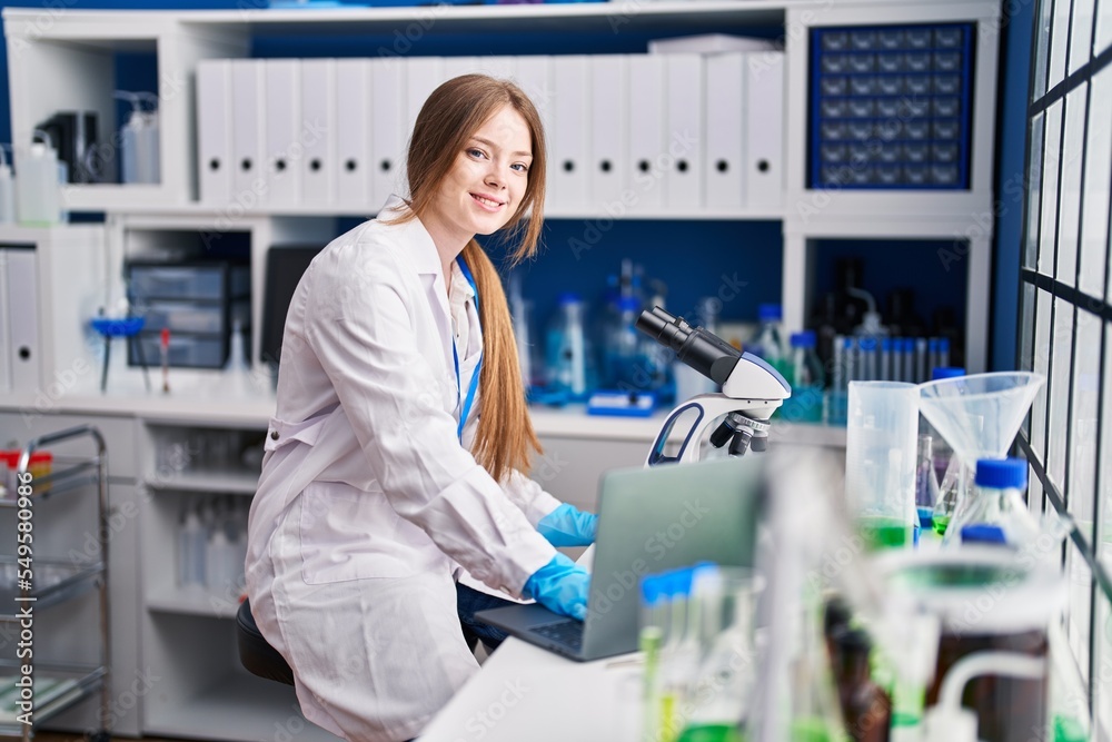 Young caucasian woman scientist smiling confident using laptop at laboratory Young caucasian woman scientist smiling confident using laptop at laboratory